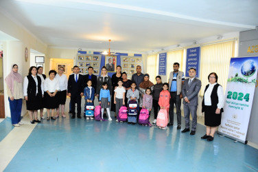 Children from low-income families were presented with school supplies and bags