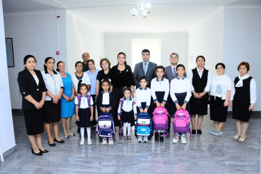 Children from low-income families were presented with school supplies and bags